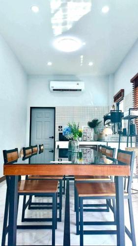 a dining room with a table and chairs at TwoEightsix 286 Poolvilla in Ban Khun Thale