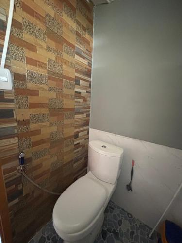 a bathroom with a white toilet in a room at Maru Vibe Guest house at Panicsican San Juan Elyu in San Juan