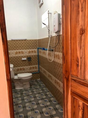 a bathroom with a toilet and a shower at XAIYASITH guesthouse in Nongkhiaw