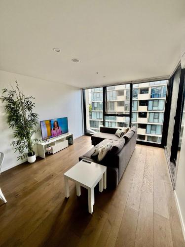 a living room with a couch and a table at City-Self check in-Parking-Pool in Canberra