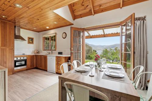 a kitchen and dining room with a table and chairs at Otago Cottage in Hobart