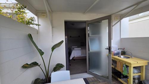 a bathroom with a glass door and a sink at Lily's Rest, Village on Silwerstrand, Robertson in Robertson