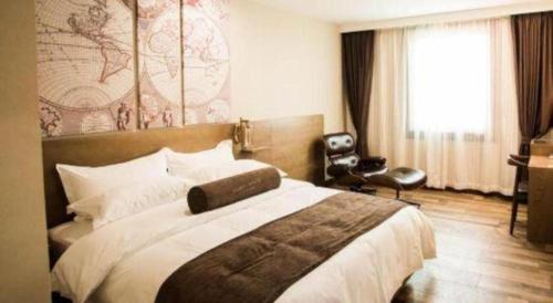 a bedroom with a large bed and a window at James Joyce Coffetel Baoding Railway Station in Baoding