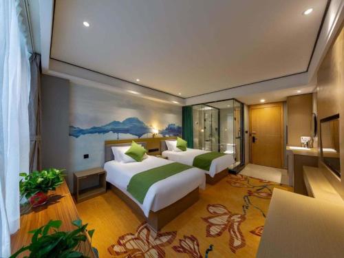 Ένα ή περισσότερα κρεβάτια σε δωμάτιο στο Shell Hotel Anhui Huaibei Railway Station Huiyuan Road