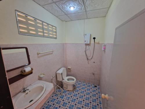 a bathroom with a tub and a toilet and a sink at Rim Khao Jungle Resort Koh Lanta in Ko Lanta