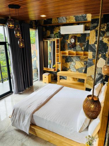 a bedroom with a large bed in a room at Dhanudi Homestay in Ella
