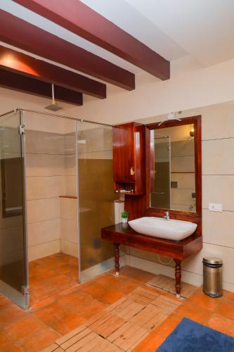 a bathroom with a sink and a shower at Mount Retreat Resorts - Madurai in Madurai