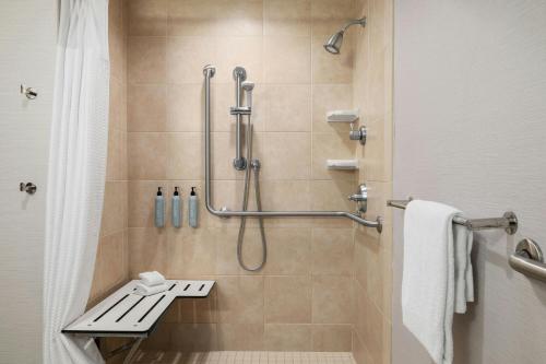 ein Bad mit einer Dusche, einem Waschbecken und einer Dusche in der Unterkunft Courtyard Des Moines Ankeny in Ankeny