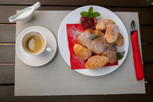 a plate of pastries and a cup of coffee on a table at Emmar Zlatograd in Zlatograd