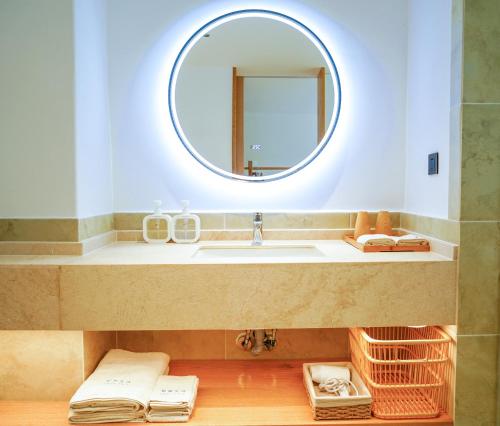 a bathroom with a sink and a mirror at 悦田生活酒店 in Gaotian