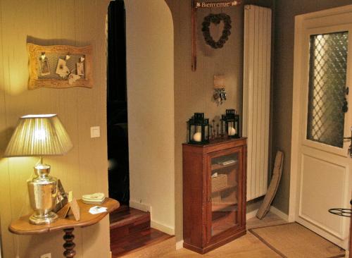 a room with a table and a lamp and a door at Chambre d'Hôtes La Villa Molina in Besançon