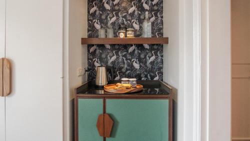 a shelf with a plate of food on it in a hallway at MiraNamin Nest KAMANTIGI - Two Bed Suite in Historic Home with Luxury Indoor Plunge Pool, Garden Access, Self-Service Breakfast, Guest Kitchen, Pet-Friendly in Manila