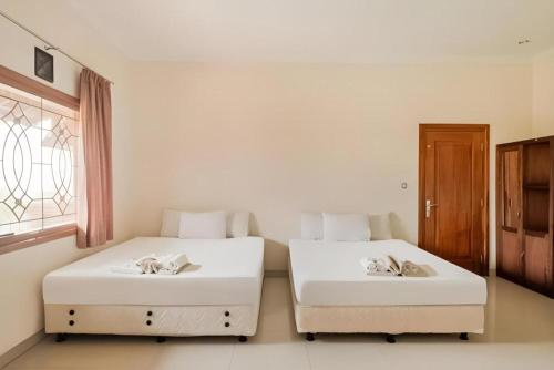 Postel nebo postele na pokoji v ubytování OYO 3396 Sun Garden Resort