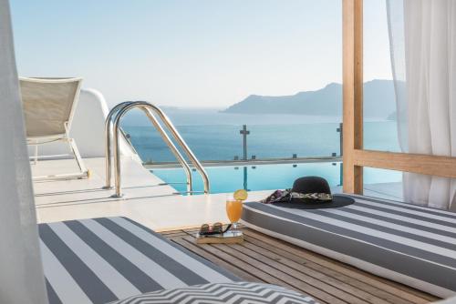 a bedroom with a view of the ocean on a yacht at Elite Luxury Suites in Oia