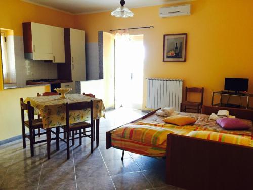 a bedroom with a table and a bed and a dining room at Agriturismo Azzarone in Vieste
