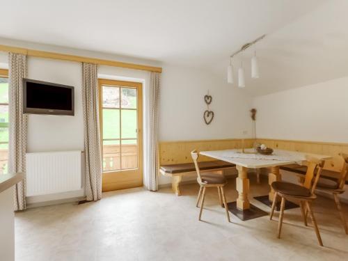 a dining room with a table and chairs at Lovely Apartment in Hainzenberg next to Forest in Hainzenberg