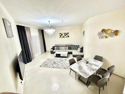 a living room with a table and a couch at Bab Al Bahr 2 BR Apartment in Ras al Khaimah