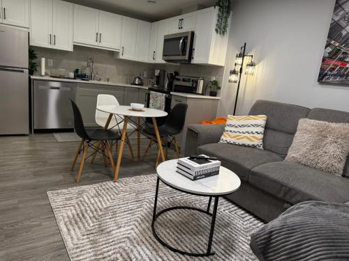 a living room with a couch and a table at Relax, Recharge, Repeat 2Bedroom Walkout Haven in Calgary