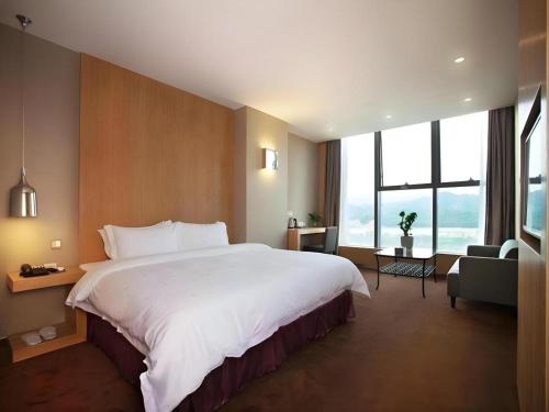 Ένα ή περισσότερα κρεβάτια σε δωμάτιο στο The Art Hotel Cai Tian Branch