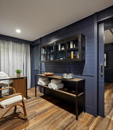 a room with blue walls and a table with towels at Delamar 4*Sup-Adults only (18+) in Lloret de Mar