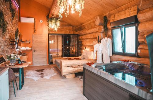 a bathroom with a sink and a bed in a room at Les biquettes Amoureuses in Carspach