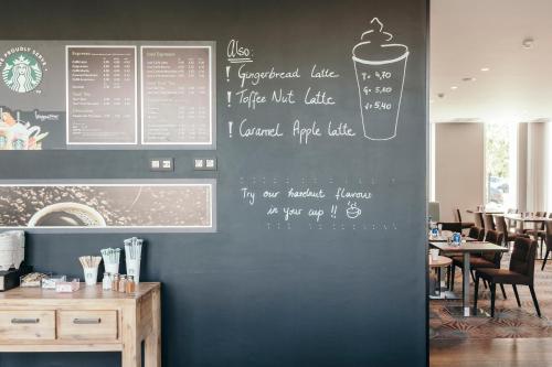 a restaurant with a menu on the wall at Leopold Hotel Oudenaarde in Oudenaarde