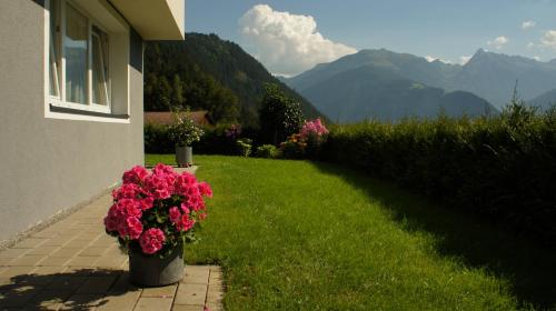 a house with flowers on the side of a yard at Bergblick in Finkenberg