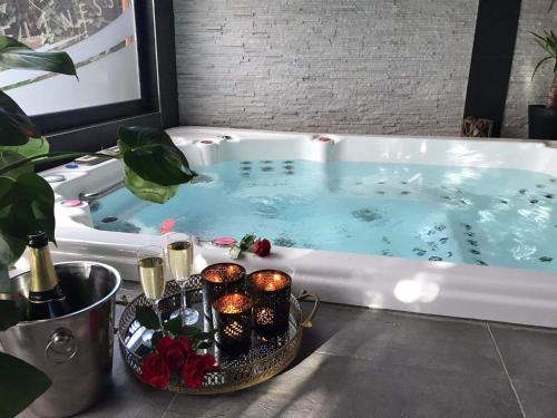 a hot tub with a tray of cupcakes in it at Duplex 7 avec Spa Privé in Herstal