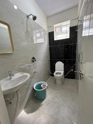 a bathroom with a sink and a toilet at Vista inn in Bangalore