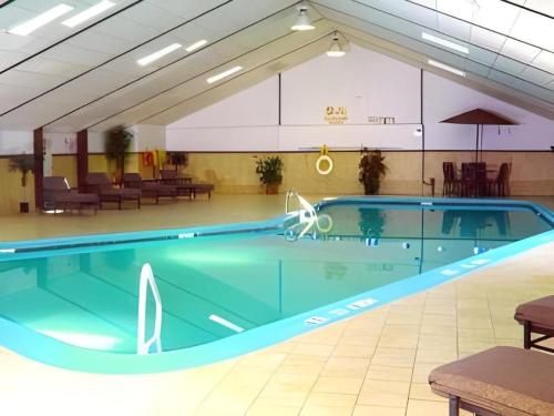 a large swimming pool in a building with a pool at Garden Plaza Hotel in Passaic Junction