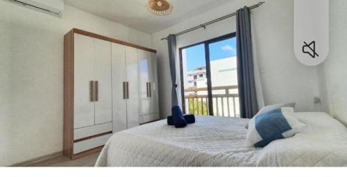 a bedroom with a large bed and a large window at Oasis Apartment in Pereybere