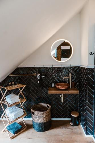 a bathroom with a sink and a mirror at Boutique Hotel Marie Marie in Dendermonde