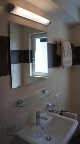 a bathroom with a sink and a mirror at Bergblick in Finkenberg