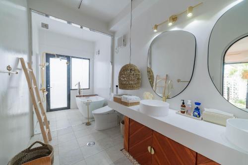 a bathroom with two sinks and a mirror at The House By The Sea in Miyako-jima