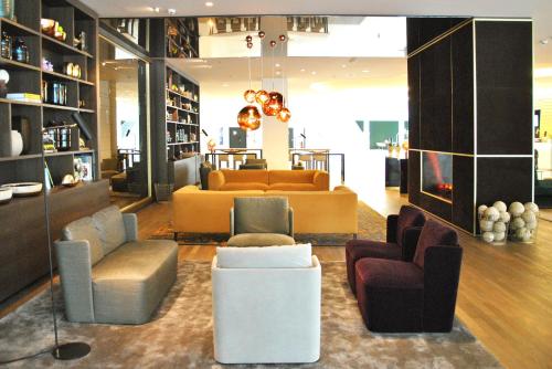 a lobby with couches and chairs in a store at Vienna House by Wyndham Andel's Berlin in Berlin