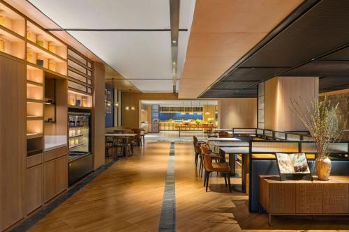 a kitchen and dining room with a table and chairs at Four Points by Sheraton Kunming, Downtown in Kunming