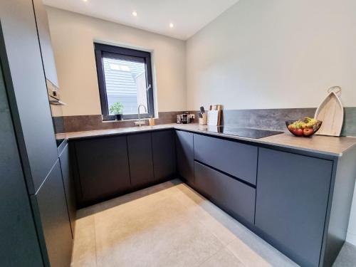 a kitchen with a sink and a window at Luxurious detached water villa with jetty in Balk