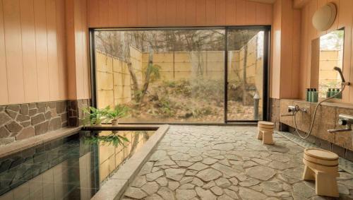 a bathroom with a large window and a sink and a toilet at 來Lai 北軽井沢Resort Villa 158 in Tsumagoi