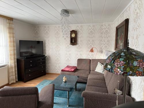 a living room with a couch and a tv at Ferienhaus in Grevesmühlen