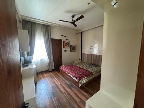 a bedroom with a bed and a ceiling fan at NTH Villa in Udaipur