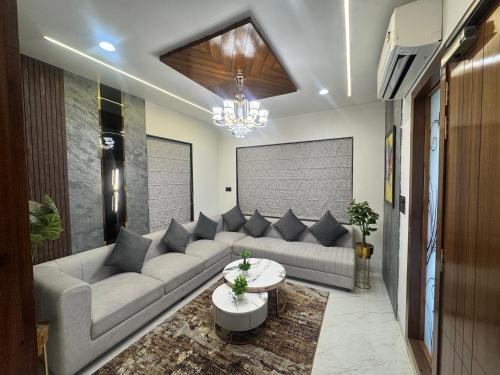 a living room with a couch and a table at NTH Villa in Udaipur