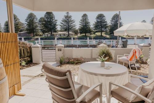 a patio with a table and chairs on a patio at The Waterfront Apartment in Port Fairy