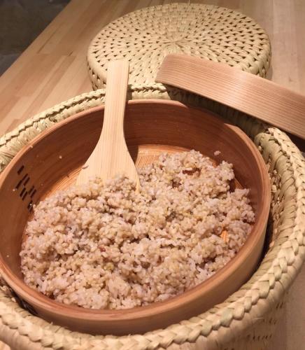 a bowl of rice with a wooden spoon in it at 稲花 TŌKA Stay&Retreat Sauna,Guided Tours & Farm Life with Animals in Kitsuki