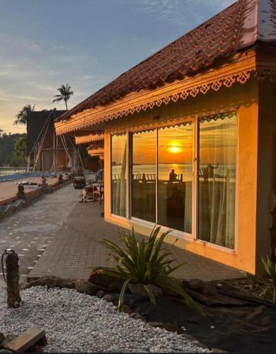 a building with large windows on the beach at Best Seller Beach Villa Full View At Kohchang Resort in Ko Chang