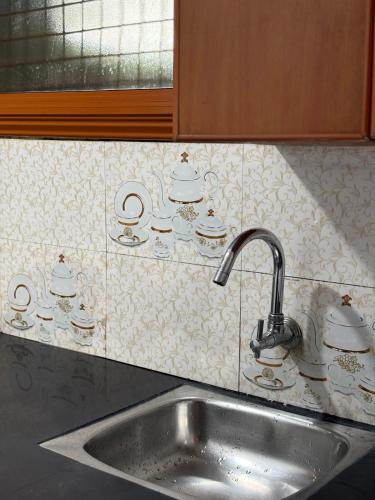 a kitchen counter with a sink and a sink at SurfN Tides by BHoomiKA in Kappil