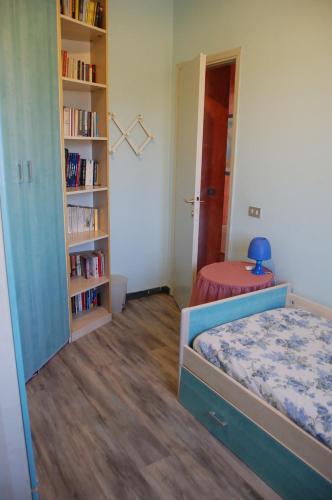 a bedroom with a bed and a book shelf at Casa Pilar in Capannori