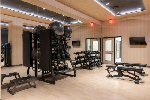a fitness room with several racks of exercise equipment at AC Hotel by Marriott Burlington in Burlington