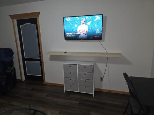 a flat screen tv hanging on a wall at Bujaks in Inuvik