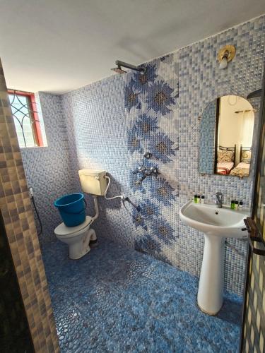 a bathroom with a toilet and a sink at Matilda Guest house in Calangute
