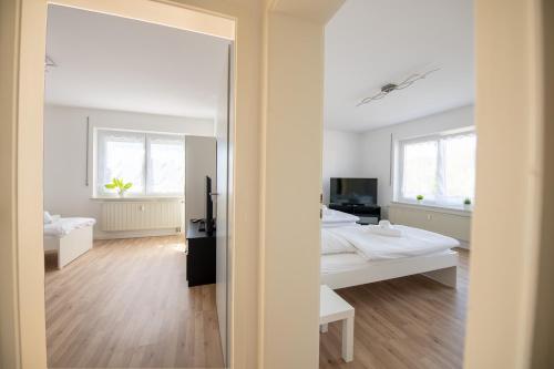 a bedroom with a bed and a mirror at WundP Living Wohnung mit Terrasse Parkplatz in Biberbach